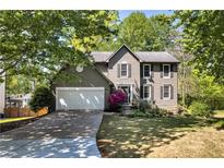 Charming two-story home with a well-manicured lawn, lush landscaping and a two-car garage at 4095 Fastnet Ln, Duluth, GA 30096