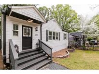 Charming home featuring a black front door, gray stairs, and decorative lanterns at 308 Greenwood Ave, Decatur, GA 30030