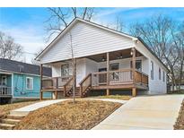 Charming bungalow-style house with a welcoming front porch and modern design elements at 907 Oakhill Sw Ave, Atlanta, GA 30310