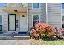 Charming front entrance with a beautiful flower bush and well-maintained landscape at 1119 Riverbend Club Se Dr, Atlanta, GA 30339