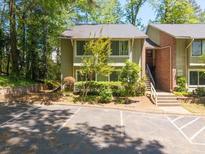 Two-story townhome with light green siding, parking in front, and a small garden at 2102 Palmyra Se Dr, Marietta, GA 30067