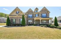 Beautiful two-story home with brick facade and manicured front yard at 2315 Saddle Brook Trce, Cumming, GA 30040