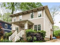 Charming two-story home featuring a cozy front porch and a well-manicured front yard at 286 Norwood Ne Ave, Atlanta, GA 30317