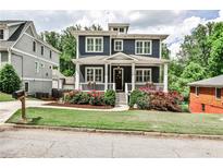 Charming two-story home with a welcoming front porch and beautifully landscaped yard at 144 Park Dr, Decatur, GA 30030
