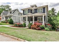 Charming two-story home with a landscaped yard and inviting front porch, perfect for relaxing or entertaining at 144 Park Dr, Decatur, GA 30030