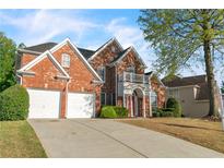 Beautiful two-story brick home with a two car garage and well maintained lawn at 1410 White Flowers Ln, Lawrenceville, GA 30045