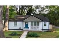Charming home featuring a blue front door, white painted brick, and cozy front porch with seating at 2447 Hillside Ave, Decatur, GA 30032