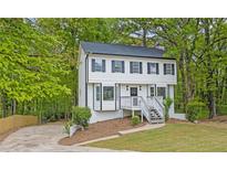 Charming two-story home with a well-maintained front yard and lush landscaping at 3905 Mill Glen Dr, Douglasville, GA 30135