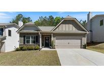 Charming single-Gathering home with a well-manicured lawn and inviting two-car garage on a sunny day at 401 Daffodil Dr, Temple, GA 30179