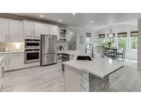 Beautiful kitchen featuring white cabinetry, stainless steel appliances, and a stylish island with stone accents at 7035 W Mountain Xing, Cumming, GA 30041
