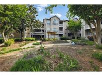 Beautiful condo exterior with landscaped grounds and a charming pergola feature at 1250 Parkwood Circle Se # 1110, Atlanta, GA 30339