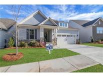 Charming home featuring manicured lawn, stone accents, attached two car garage and inviting entryway at 159 Sunshower Rdg, Canton, GA 30114