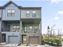 Charming townhome with a modern design, covered balconies, and an attached garage at 200 Chestnut Cir, Atlanta, GA 30342