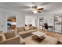 Bright living room boasts hardwood floors, modern furnishings, and a ceiling fan for added comfort at 1426 N Crossing Ne Dr, Atlanta, GA 30329