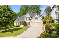 Charming two-story home featuring a manicured front lawn and a two-car garage at 3105 Birchton St, Johns Creek, GA 30022
