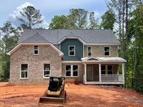 Beautiful two-story brick home with a welcoming front porch and gray trim at 3294 Mill Forest Dr, Conyers, GA 30094