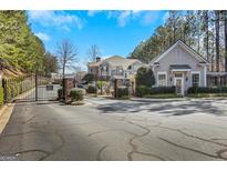Gated community entrance with manicured landscaping and controlled access for added security and privacy at 2400 Cumberland Se Pkwy # 803, Atlanta, GA 30339
