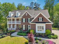 Beautiful two-story brick home with black shutters and lush landscaping at 3115 Corsair Curv, Cumming, GA 30040