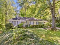 Charming single-story home with a lush front yard, mature trees, and neutral siding at 1715 E Clifton Ne Rd, Atlanta, GA 30307