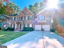 Beautiful brick home featuring a two-car garage and well-manicured lawn at 2818 Willowstone Dr, Duluth, GA 30096