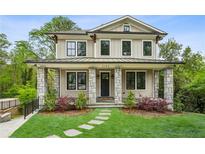 Charming two-story home with stone accents, a manicured lawn, and a welcoming front porch at 2193 Virginia Ne Pl, Atlanta, GA 30305