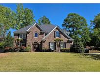 Beautiful brick home with a well-manicured lawn and lush landscaping creates great curb appeal at 2227 Austin Lake Se Dr, Smyrna, GA 30082