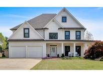 Charming two-story home with a manicured lawn and attached two car garage at 541 Lombard St, Marietta, GA 30064