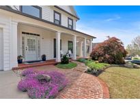 Charming front yard with a brick walkway leading to the inviting front porch and beautifully landscaped garden at 541 Lombard St, Marietta, GA 30064