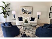 Bright living room features a modern white couch, contemporary art, and stylish decor at 2674 Ne Almand Ne Ln, Conyers, GA 30013