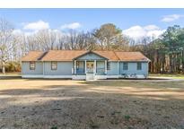 Charming single-story home with a welcoming front porch, manicured lawn, and a peaceful setting at 900 Stone Lea Trce, Oxford, GA 30054