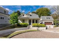 Charming home with landscaped front yard, welcoming porch, and detached garage providing great curb appeal at 216 Haralson Ne Ln, Atlanta, GA 30307