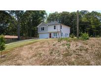 Charming two-story home with a modern design, attached garage and beautifully maintained lawn at 1331 E Atlanta E Rd, Stockbridge, GA 30281
