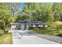 Charming single-story home with a well-manicured lawn and inviting curb appeal, surrounded by mature trees at 4462 Cain Cir, Tucker, GA 30084