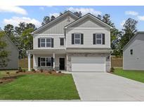 Charming two-story home with a well-maintained lawn and a two-car garage at 529 Lanier Way, Temple, GA 30179