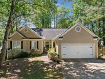 Charming one-story home featuring a two-car garage and a well-maintained front yard at 614 Springharbor Dr, Woodstock, GA 30188