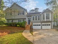 Charming two-story home with attached two car garage and landscaped front yard at 1307 Chandler Nw Ct, Acworth, GA 30102