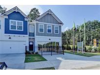 Charming two-story townhome with attached garage, landscaping, and a welcoming entrance in a residential neighborhood at 2688 Ne Almand Lane Ne, Conyers, GA 30013