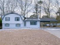 Charming two-story home featuring a carport and freshly painted exterior with lovely trim at 2637 Sol Ct, Ellenwood, GA 30294