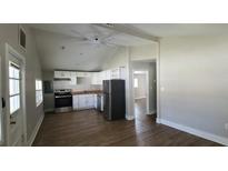 Open kitchen features white cabinets, modern appliances, and wood-look flooring at 2917 Joe Jerkins Blvd, Austell, GA 30106