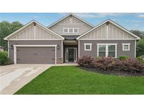 Charming single-story home with well-maintained lawn, gray siding, and inviting entrance at 6340 Arlington Cir, Cumming, GA 30041