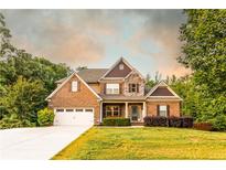 Charming two-story brick home with a well-manicured lawn and attached two car garage at 632 Creekside Trce, Covington, GA 30014