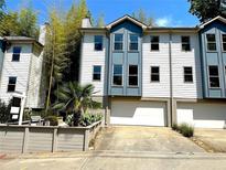 Charming townhome featuring a two-car garage and blue and white exterior paint at 738 Saint Charles Ne Ave, Atlanta, GA 30306
