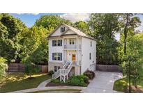 Charming three-story home featuring a welcoming entryway and a well-manicured front yard at 2136 Oak Knob Dr, Decatur, GA 30032