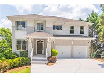 Beautiful two-story home featuring a two-car garage, stone accents, and manicured landscaping at 2675 Sugar Mill Dr, Atlanta, GA 30316