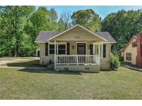 Charming bungalow featuring a cozy front porch and inviting curb appeal at 4076 Blanton Sw Ave, Atlanta, GA 30331