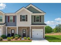 Charming two-story townhome featuring a brick facade, attached garage, and well-maintained landscaping at 8609 Lakeview, Jonesboro, GA 30238