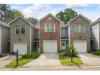Charming townhomes feature diverse facades and attached garages, adding to their curb appeal at 5570 Stonewood Ct, Norcross, GA 30093