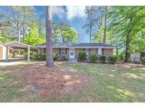 Charming one-story brick home with a well-maintained lawn and covered carport at 190 Sunrise Cir, Riverdale, GA 30274