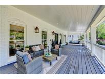 Inviting covered patio with comfortable seating, stylish decor, and a relaxing porch swing at 5567 Stapleton Dr, Dunwoody, GA 30338
