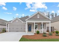 Charming single-story home with a welcoming front porch, well-manicured lawn and attached two-car garage at 1220 Cedarcrest Blvd, Acworth, GA 30101